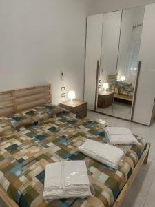 a bedroom with a large bed with towels on it at Casa Vacanze Nautilus in Termoli