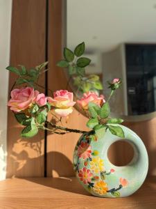 a vase with flowers in it sitting on a table at Huong Sky Co To in Chung Cap