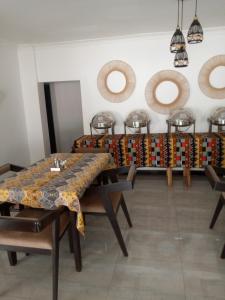 a dining room with a table and chairs at Natisa Lodge in Livingstone +1 photo