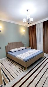 a bedroom with a large bed in a room at Яншина 2 in Qyzylorda