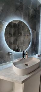 a bathroom with a sink and a mirror at Яншина 2 in Qyzylorda +14 photos