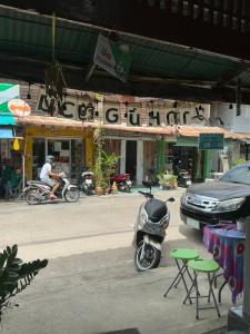 a motor scooter parked on the side of a street at Baan Yuan in Prachuap Khiri Khan
