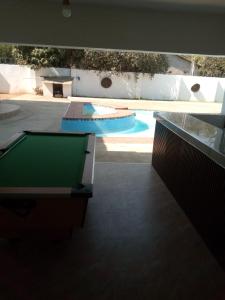 a pool with a pool table in the middle of a house at Natisa Lodge in Livingstone