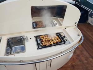 a grill on a boat with food on it at Houseboat Dolce Vita in Novigrad Istria