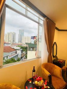 a room with a window and a table with wine glasses at Vera Luxury Hotel in Hanoi