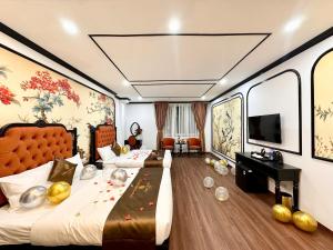 a hotel room with a bed and a tv at Vera Luxury Hotel in Hanoi