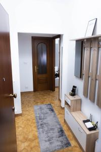 a room with a hallway with a door and a rug at House Santa Rita in Turin +15 photos