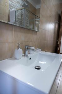 a bathroom with a white sink and a mirror at House Santa Rita in Turin
