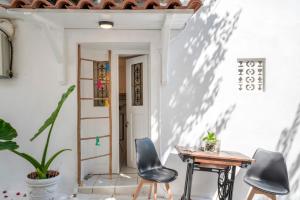 a room with a table and chairs and a door at Bougainvillea in Andros