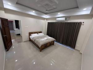 a small bedroom with a bed and a radiator at 3BHK Villa 15 min Thommankuthu Falls Groups in Thodupuzha
