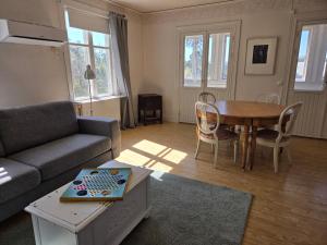 a living room with a couch and a table at Vandrarhemmet Tallbacka/Ängelsberg Hostel in Ängelsberg