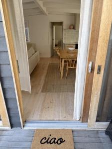 a open door to a living room with a table at Casa Piccolo - Peninsula Hot Springs 5 mins away in Rye