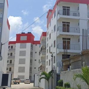 a building with a car parked in front of it at Homes by Najma in Mtwapa
