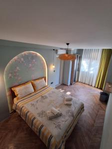 a bedroom with a large bed with a large headboard at Elia Hotel Alaçatı in Çeşme