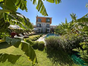 a resort with a swimming pool and a building at Elia Hotel Alaçatı in Çeşme