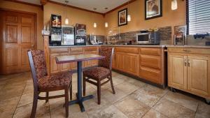 a kitchen with a table and chairs and a counter at Best Western Martinsville Inn in Martinsville