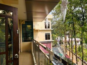 a balcony of a house with a building at 3BHK Villa 15 min Thommankuthu Falls Groups in Thodupuzha