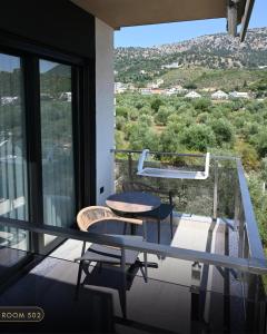 a balcony with a table and chairs and a view at Elmares Hotel in Himare