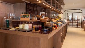 a kitchen with a counter with food on it at Hotel Medium Montecarlo in Llafranc