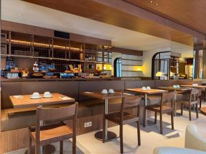 a dining room with wooden tables and chairs at Hotel Medium Montecarlo in Llafranc