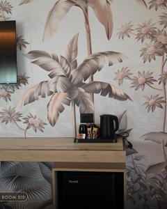 a room with a wall with a palm tree mural at Elmares Hotel in Himare