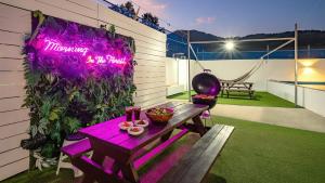 a purple sign on the side of a house with a table at Geoje Forest-Morning Spa Pension in Geoje