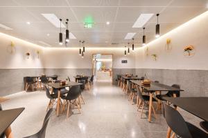 a dining room with black tables and chairs at Atour S Hotel Beijing Anzhen in Beijing