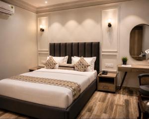 a bedroom with a large bed and a desk at Elegance Regency in Khanna