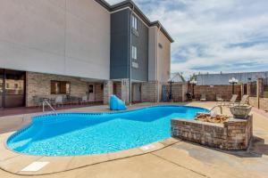 a swimming pool in the backyard of a house at Comfort Inn & Suites McComb in McComb +17 photos