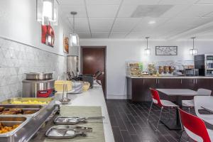 a kitchen with a counter with food on it at Quality Suites Pineville - Charlotte in Charlotte