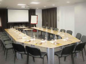a conference room with a long table and chairs at ibis Istres Trigance in Istres +34 photos