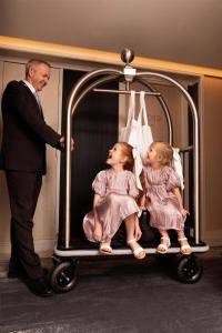 a man standing next to two little girls in a baby carriage at Parmelia Hilton Perth in Perth +83 photos