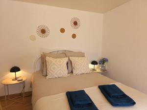 a bedroom with a bed with blue towels on it at Refúgio do Zé Espanhol in Arcos de Valdevez