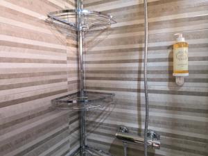 a glass shelf in the corner of a bathroom at Refúgio do Zé Espanhol in Arcos de Valdevez +32 photos