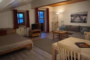 a living room with a couch and a table at Feriendorf Hauzenberg-Pool&Sauna in Hauzenberg
