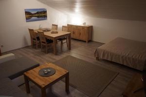 a room with a bed and a table and a bed and a room with at Feriendorf Hauzenberg-Pool&Sauna in Hauzenberg