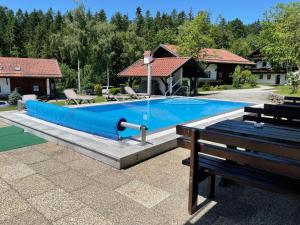 a large swimming pool with a blue pool at Feriendorf Hauzenberg-Pool&Sauna in Hauzenberg +24 photos