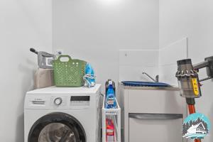 a washing machine in a kitchen with a sink at Spacious 4BR Yard Retreat in Kellyville