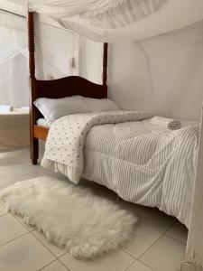 a bedroom with a bed with a canopy and a rug at Nairobi Transit Lounge in Nairobi