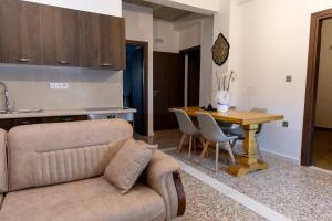 a living room with a couch and a wooden table at Vakontas Luxury Stay in Gerolimenas