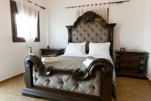 a bedroom with a large bed with a large headboard at Vakontas Luxury Stay in Gerolimenas +29 photos
