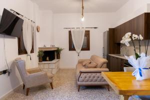 a living room with a couch and a table at Vakontas Luxury Stay in Gerolimenas