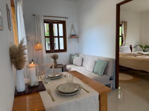 a living room with a table and a couch at Thong Sala Japandi Villa in Thong Sala