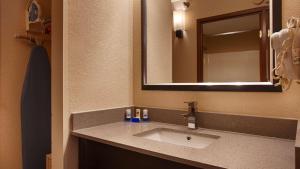 a bathroom with two sinks and a mirror at Days Inn by Wyndham Indiana Benjamin Franklin Highway in Indiana