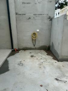 a room with a hose hanging on a wall at 滸衖海旅 in Anping +5 photos