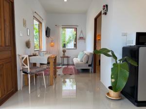 a living room with a table and a dining room at Thong Sala Japandi Villa in Thong Sala +4 photos