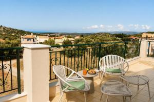 a balcony with two chairs and a table with a view at Luminosa Collection - Casa Celeste in Razáta