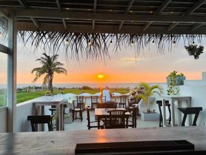 a restaurant with a view of the ocean at sunset at Seagreen Guesthouse - Galle Fort in Galle