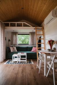 a living room with a couch and a bunk bed at Jemiołucha Glamping in Bodzentyn