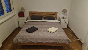 a bedroom with a large bed with two night stands at Alpine Apartment in Villeneuve